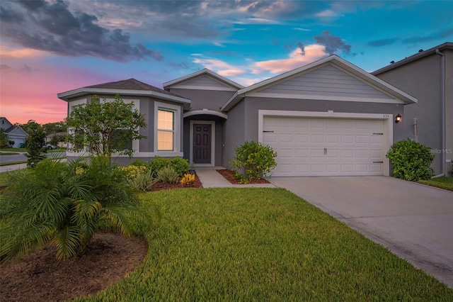 view of front of home with a lawn and a garage