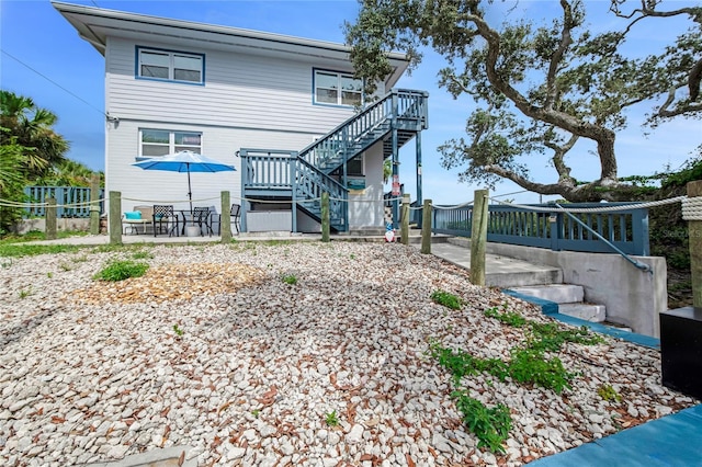 back of property with a patio area, stairway, and fence