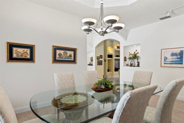 dining space featuring a notable chandelier, rail lighting, and light tile patterned flooring