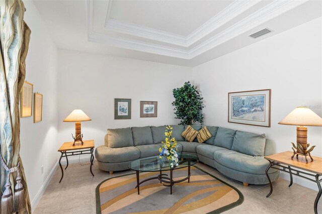 living room featuring a tray ceiling and crown molding