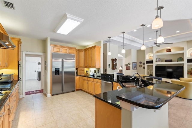 kitchen with pendant lighting, kitchen peninsula, sink, a breakfast bar, and appliances with stainless steel finishes