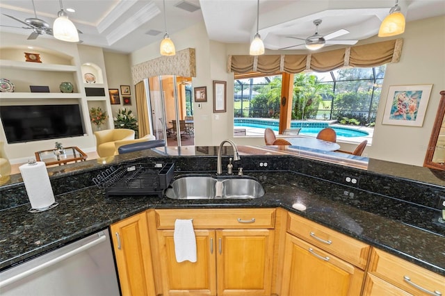 kitchen featuring dishwasher, ceiling fan, sink, and dark stone countertops