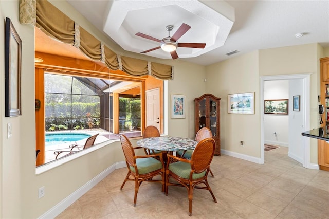 tiled dining space featuring ceiling fan