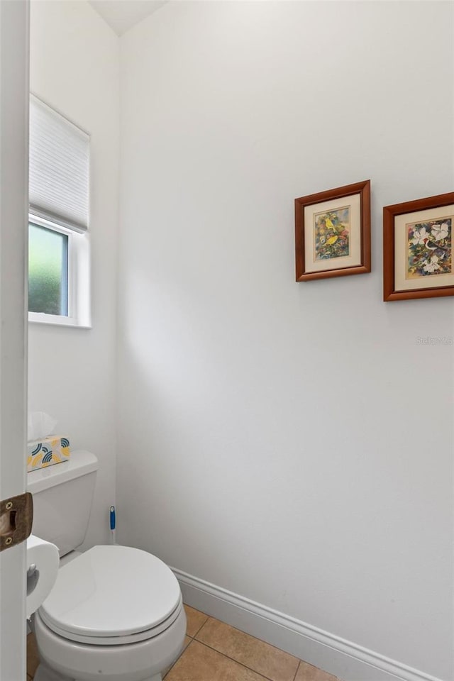 bathroom featuring toilet and tile patterned floors