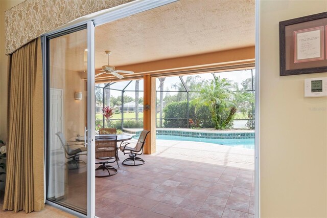 interior space featuring ceiling fan and a pool