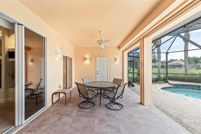 sunroom featuring ceiling fan