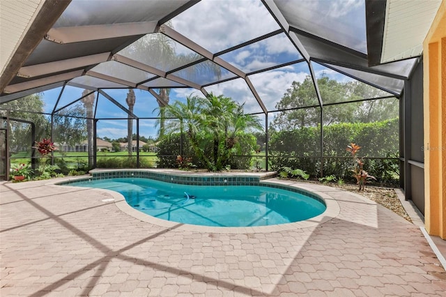 view of pool with a lanai and a patio