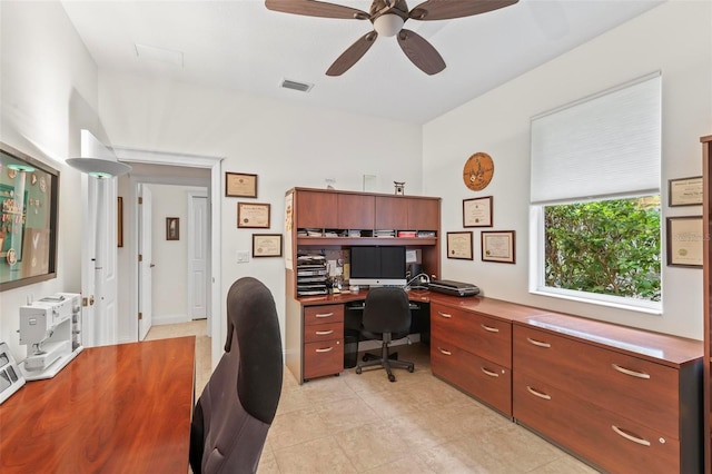 tiled home office featuring ceiling fan