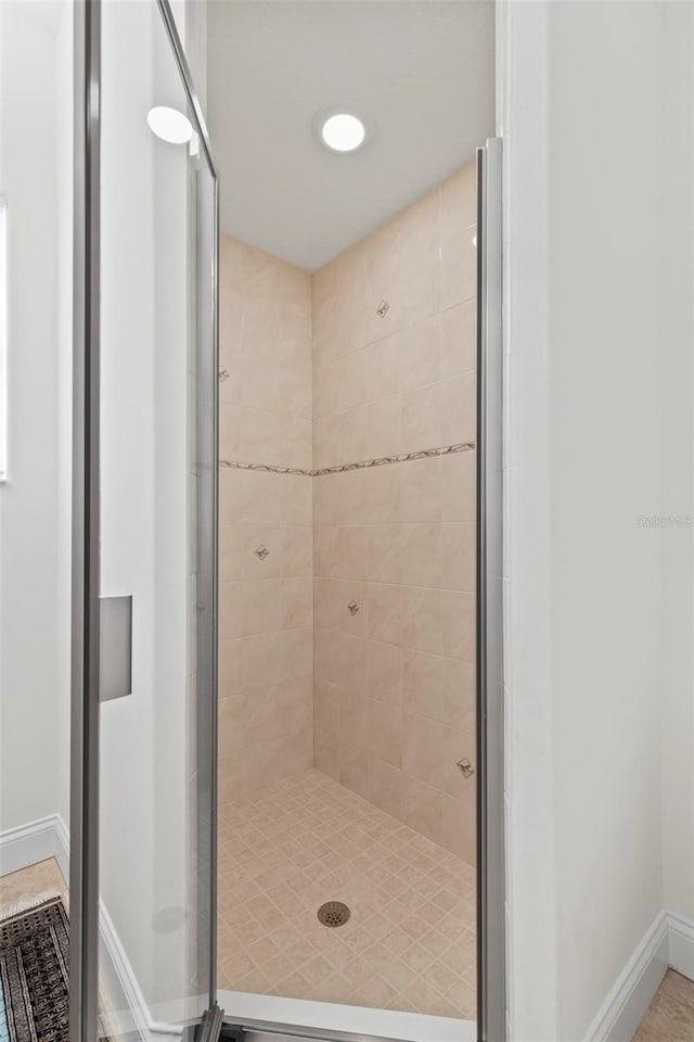 bathroom with a shower with door