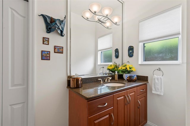 bathroom featuring vanity and a notable chandelier