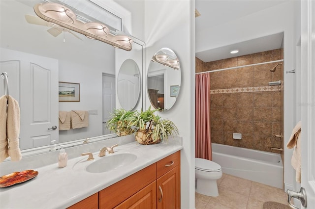 full bathroom featuring tile patterned floors, toilet, shower / bath combo with shower curtain, and vanity