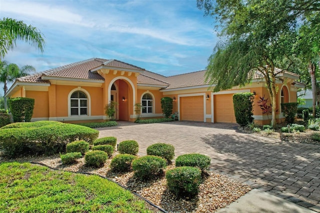 mediterranean / spanish home with a garage