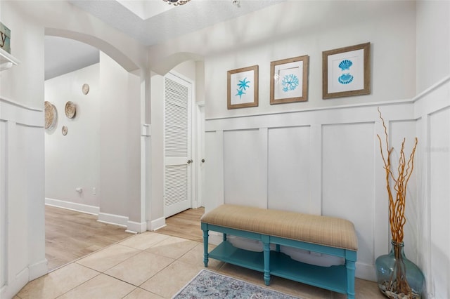 mudroom with a textured ceiling and light hardwood / wood-style floors