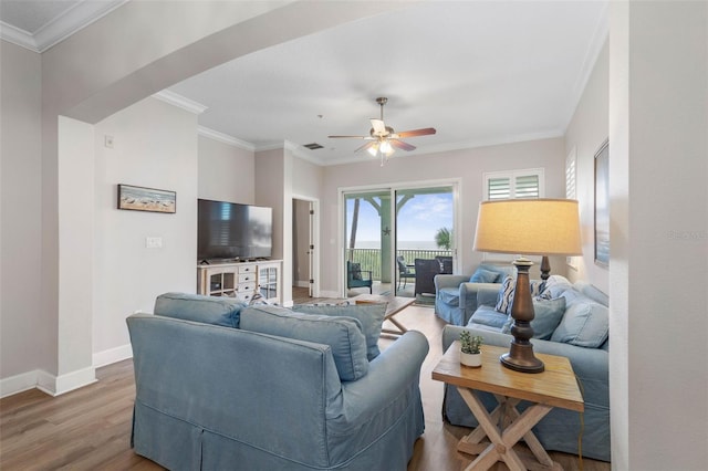 living room with ceiling fan, hardwood / wood-style flooring, and crown molding