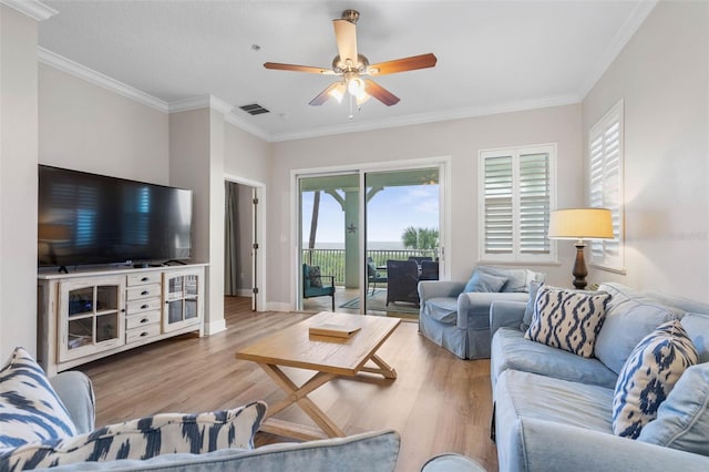 living room featuring light wood-type flooring, ornamental molding, and ceiling fan