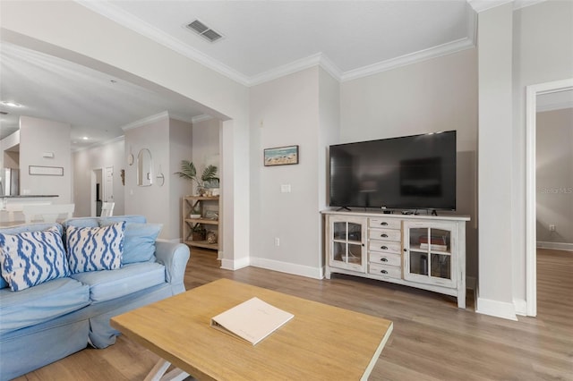 living room with wood-type flooring and crown molding