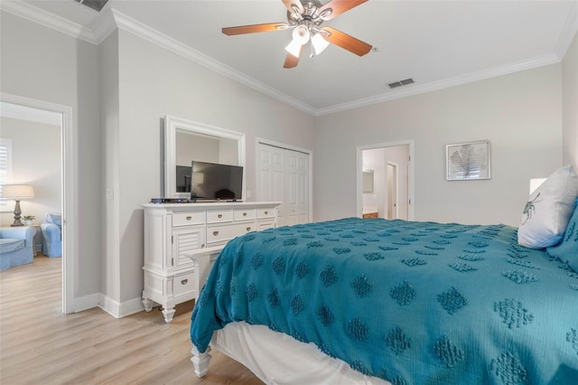 bedroom featuring ceiling fan, ornamental molding, light hardwood / wood-style flooring, a closet, and ensuite bathroom