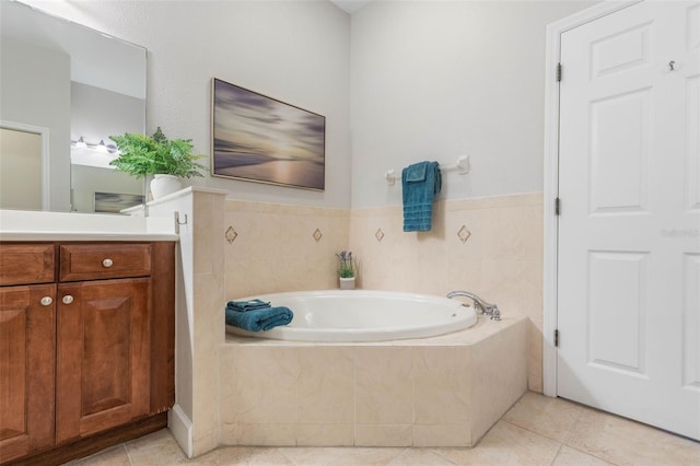 bathroom with tile walls, tile patterned flooring, tiled bath, and vanity