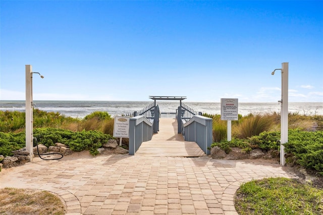 view of property's community with a view of the beach and a water view