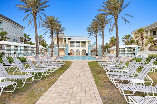 surrounding community featuring a pool and a patio area