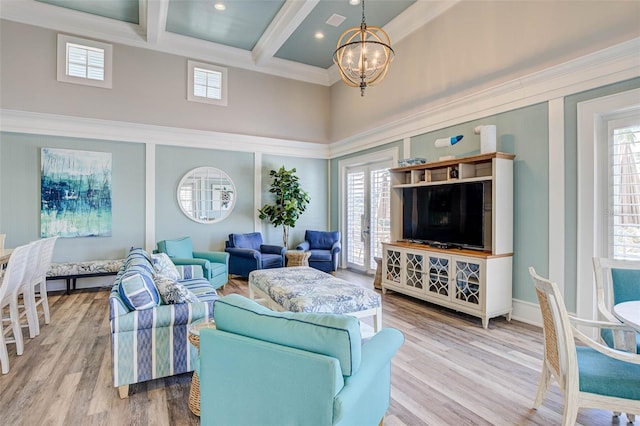 living room featuring wood-type flooring, a chandelier, beam ceiling, coffered ceiling, and crown molding