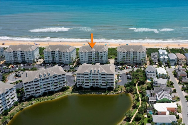 aerial view with a water view and a beach view