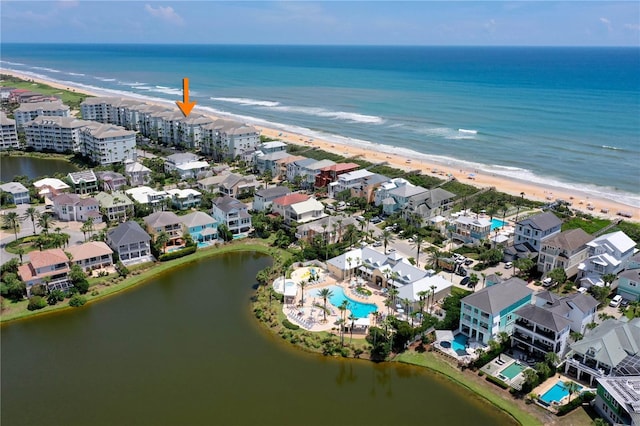 bird's eye view featuring a view of the beach and a water view