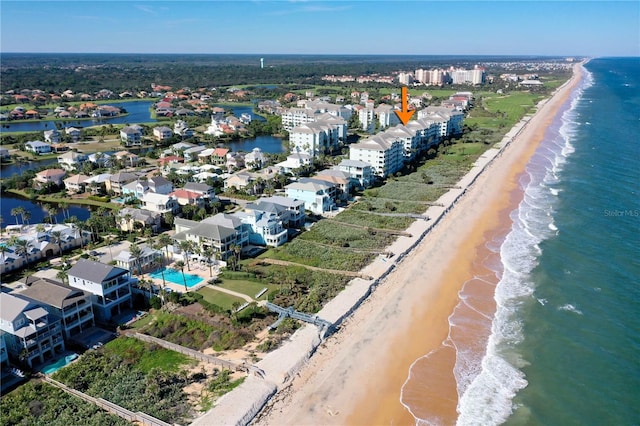 aerial view with a water view and a beach view