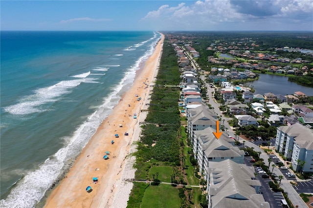 bird's eye view featuring a water view and a beach view