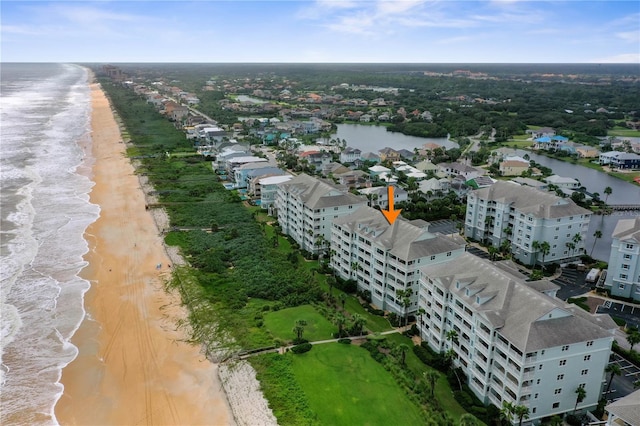 drone / aerial view with a water view and a beach view