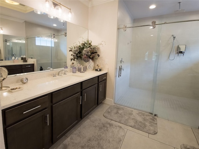 bathroom with crown molding, vanity, walk in shower, and tile patterned flooring