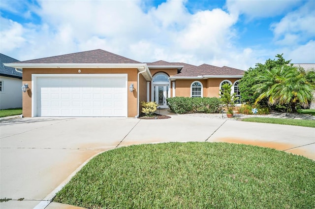 view of front of house with a garage and a front yard