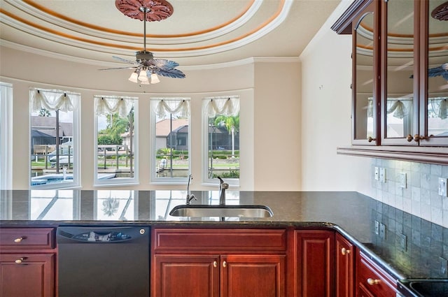 kitchen featuring crown molding, sink, a tray ceiling, black dishwasher, and ceiling fan