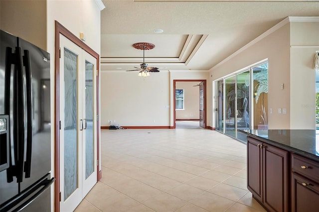 kitchen with light tile patterned floors, crown molding, stainless steel fridge, ceiling fan, and a textured ceiling