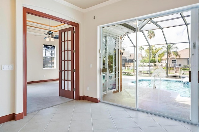 entryway with ceiling fan, ornamental molding, and light tile patterned floors