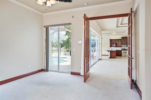 interior space with crown molding and light carpet