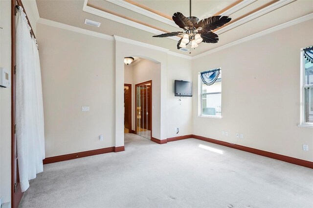 carpeted spare room featuring crown molding and ceiling fan