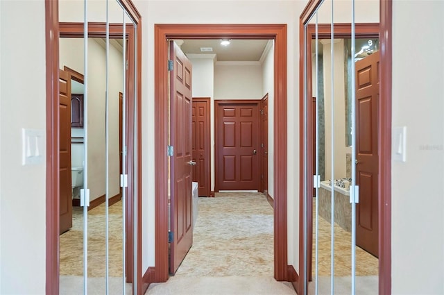 hallway featuring ornamental molding and carpet floors