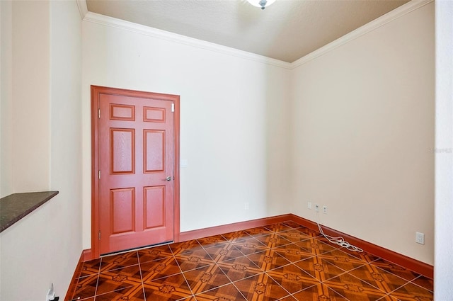 entrance foyer with dark tile patterned flooring and crown molding