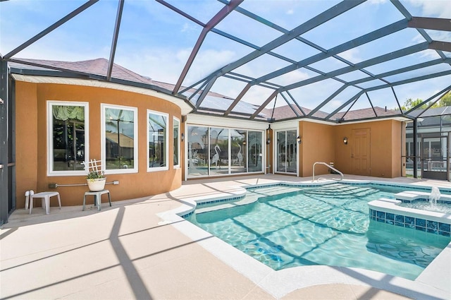 view of pool featuring a lanai, a patio area, and an in ground hot tub