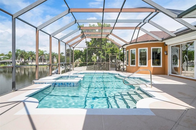 view of pool featuring glass enclosure, a water view, a patio area, and an in ground hot tub