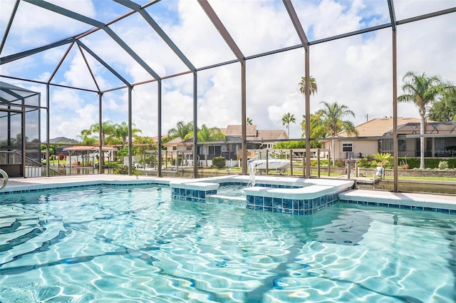 view of swimming pool with a lanai, a patio, and an in ground hot tub