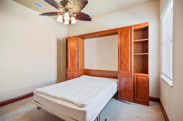 bedroom with light colored carpet and ceiling fan