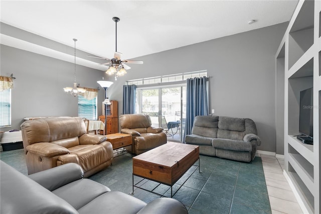 living room featuring ceiling fan with notable chandelier and tile patterned floors