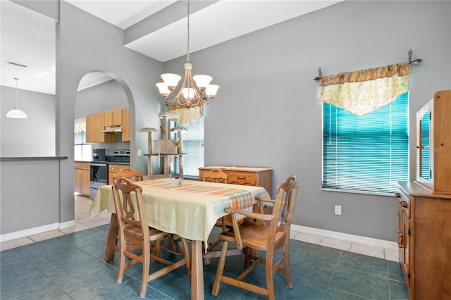 tiled dining room with an inviting chandelier and a healthy amount of sunlight