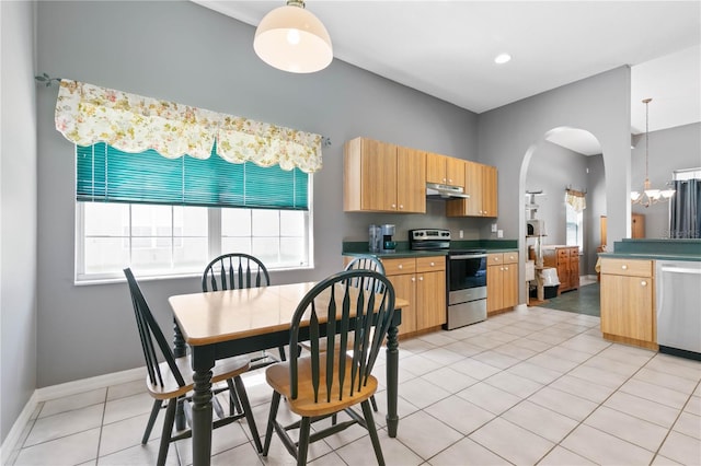 kitchen with hanging light fixtures, stainless steel appliances, and a healthy amount of sunlight