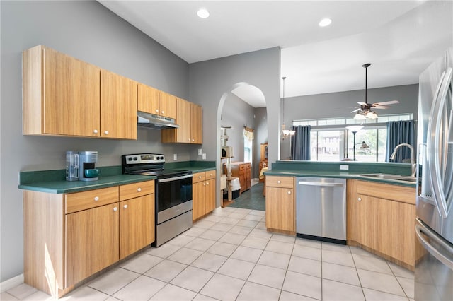 kitchen with appliances with stainless steel finishes, light tile patterned floors, sink, and ceiling fan