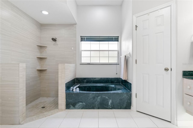 bathroom featuring vanity, tile patterned floors, and shower with separate bathtub