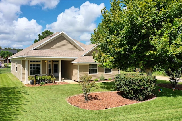 rear view of house featuring a lawn