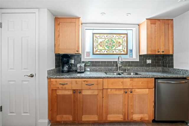 kitchen with dishwasher, tasteful backsplash, and sink